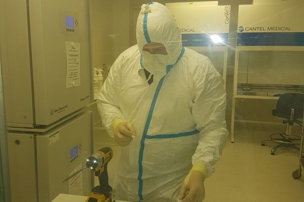 Engineer conducting vital maintenance work in sterile environment