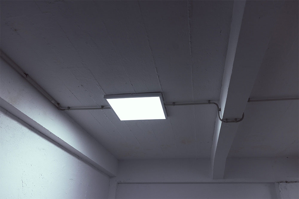 Hanging LED lights on a ceiling in an office building